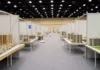 Salon DZ IMMO 2026 : plus de 30 exposants à la Safex d’Alger du 22 au 25 octobre Stands d’un salon de l’immobilier avec maquettes de résidences